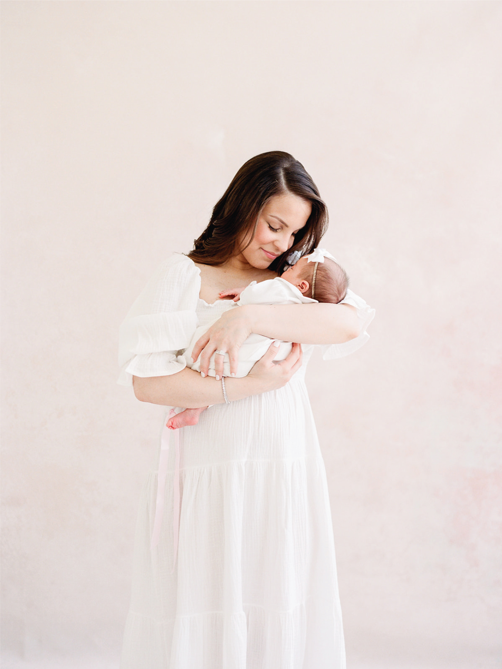 Mother cradling newborn showing best time for natural baby photos