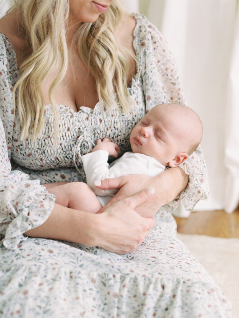 Mother cradling newborn showing best time for natural baby photos
