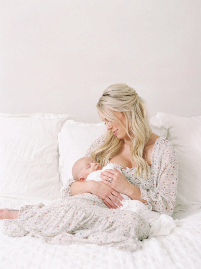 Mother cradling newborn showing best time for natural baby photos