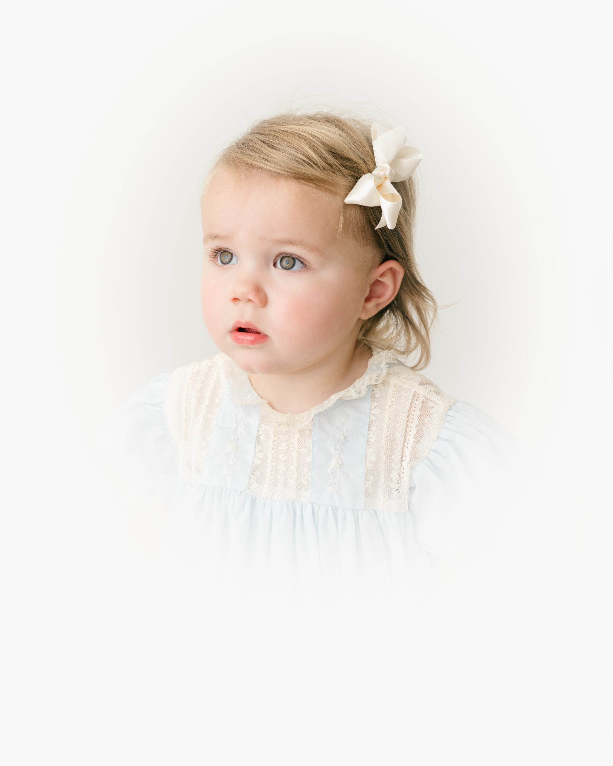 Fine-art heirloom portrait of a child with a gentle, thoughtful expression captured in soft natural light