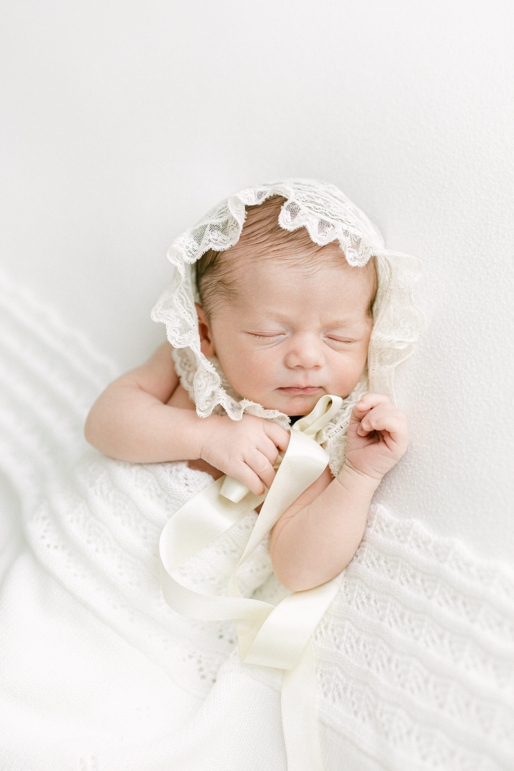 Luxury newborn photography session in Birmingham, Alabama featuring a peacefully sleeping newborn.