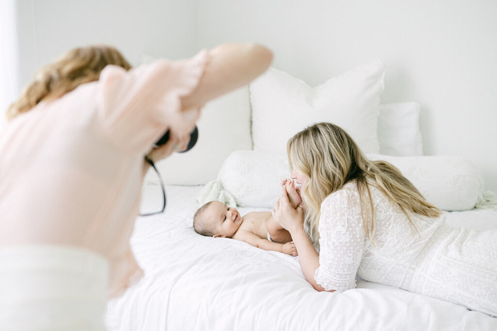 Mother cuddling her newborn during an intimate newborn photography session in Birmingham.