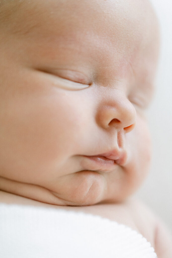 Close-up newborn photography highlighting tiny lips and nose in a Birmingham newborn studio.