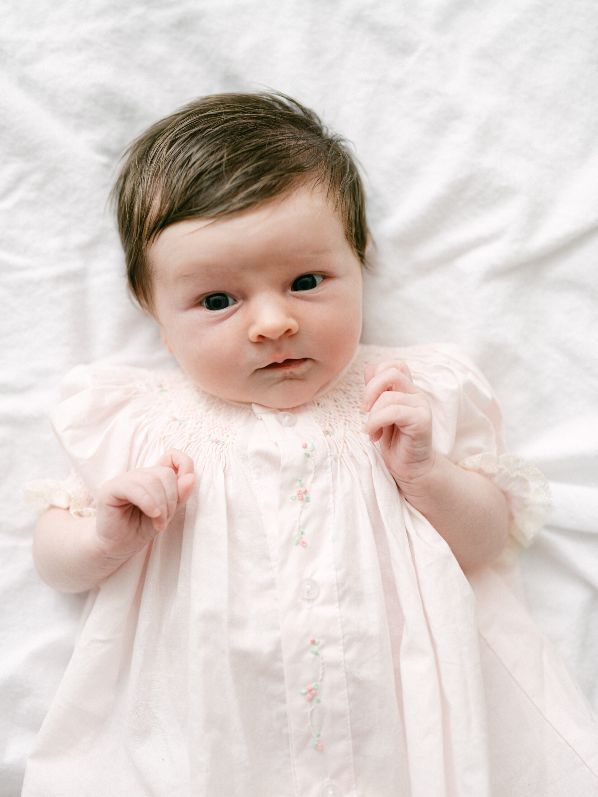 Side-by-side newborn and six-month baby portraits showing how quickly babies grow and change in their first months.