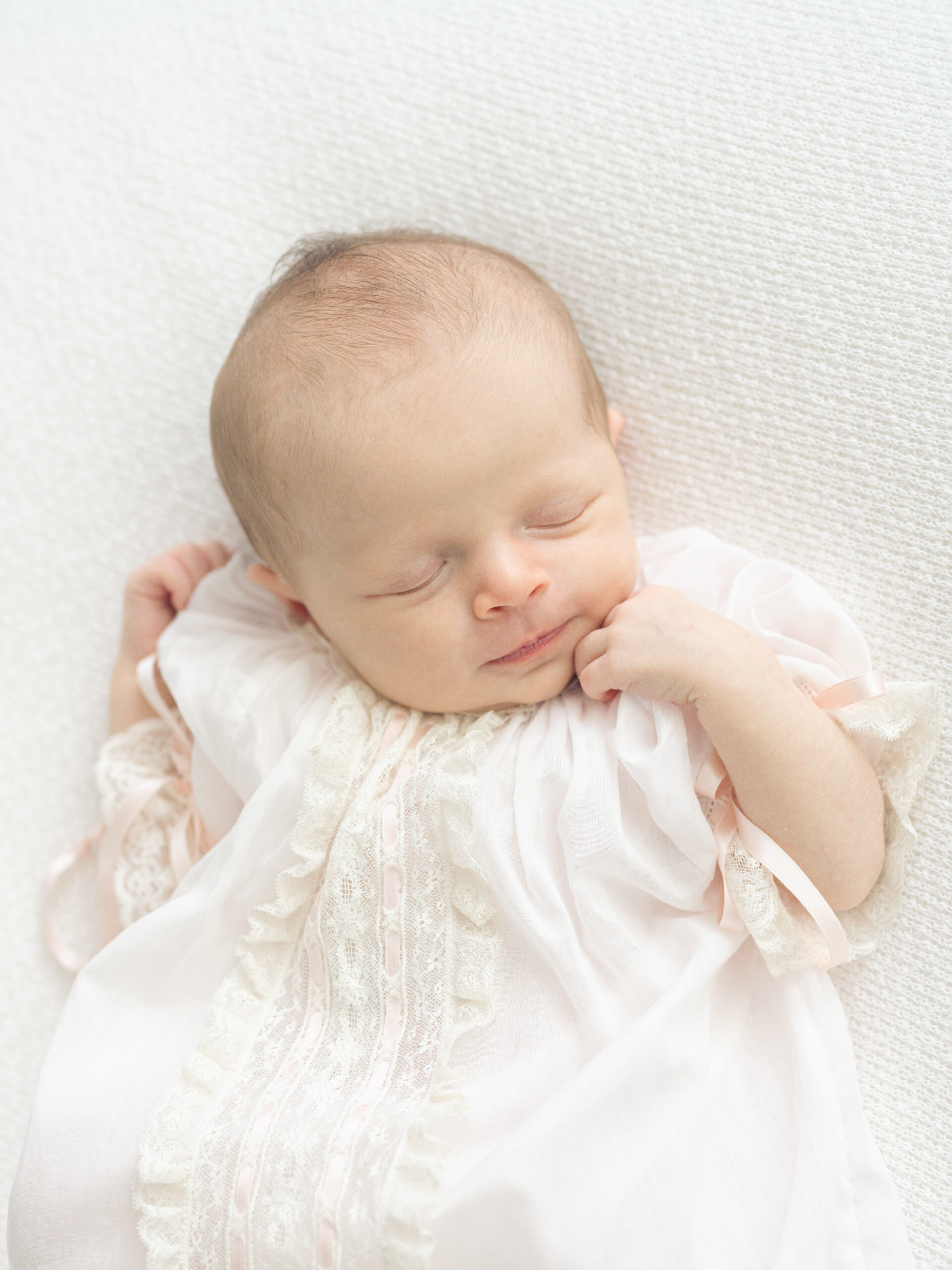Close-up newborn photography highlighting tiny hands and feet in a Birmingham newborn studio.