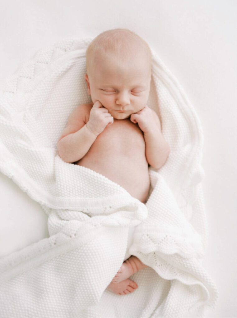 Newborn sleeping peacefully during a relaxed studio session with a luxury Birmingham newborn photographer.