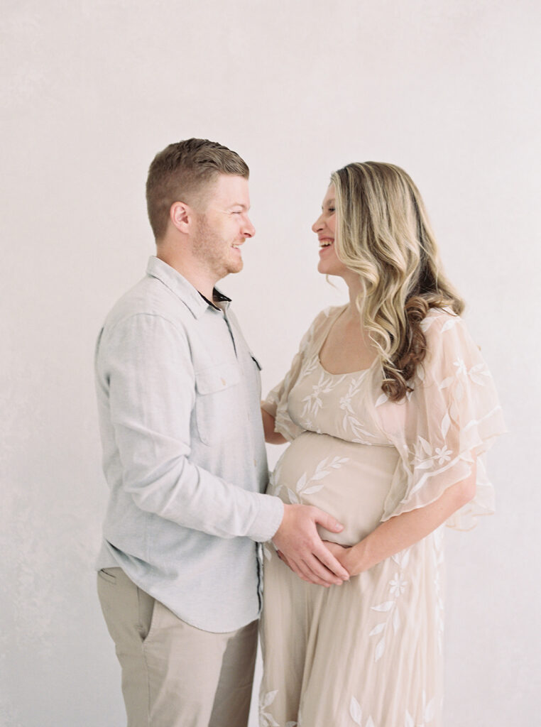 Expecting couple embracing during a luxury maternity photography session in Birmingham, Alabama.