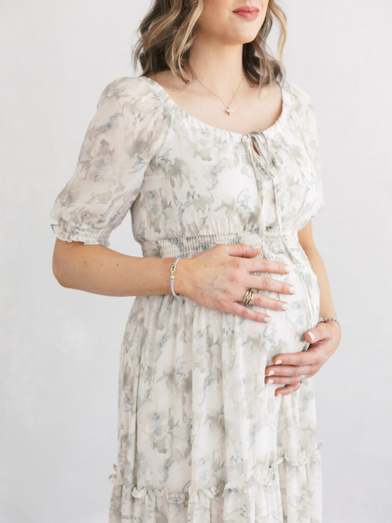 Elegant studio maternity portrait of an expecting mother photographed in soft natural light in Birmingham, Alabama.