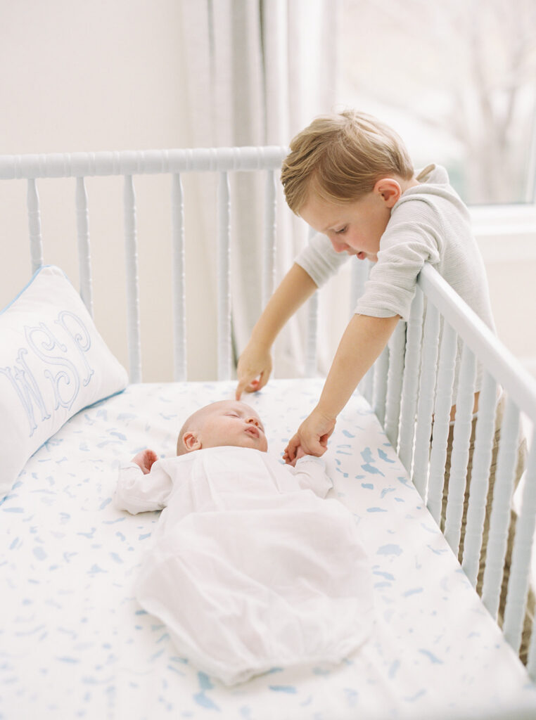 Newborn baby photographed in a beautifully designed nursery during an in-home session.
